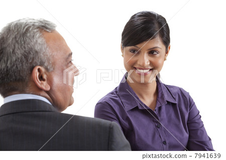 Business executives conversing on white background 7941639