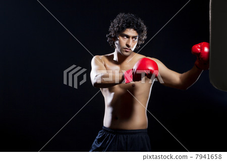 Male boxer punching the bag Male boxer punching the bag 7941658