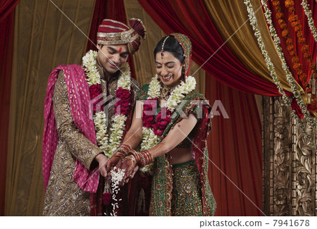 Smiling bride and bridegroom during wedding ceremony Smiling bride and bridegroom during wedding ceremony 7941678