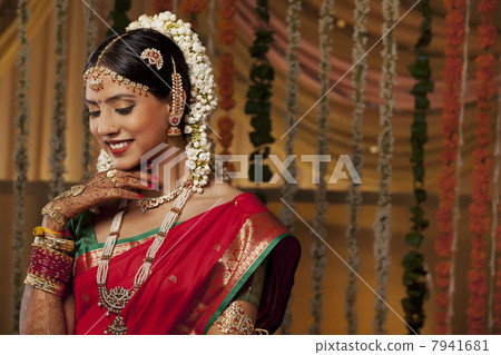 Close-up of a beautiful young woman in bride attire smiling Close-up of a beautiful young woman in bride attire smiling 7941681