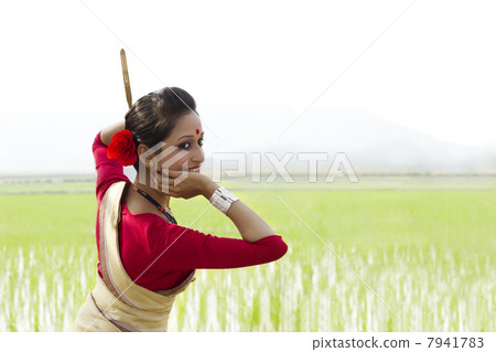 Woman performing Bihu dance 7941783