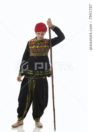 Portrait of a male dandiya dancer with a stick 7941787
