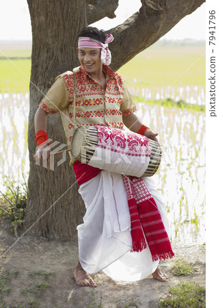 Portrait of Bihu man playing on a dhol Portrait of Bihu man playing on a dhol 7941796