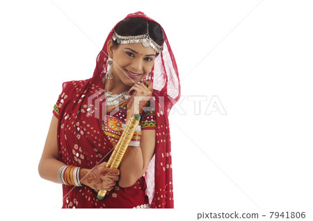 Portrait of a female dandiya dancer with sticks 7941806