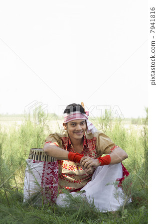 Portrait of a Bihu dancer sitting with a dhol 7941816