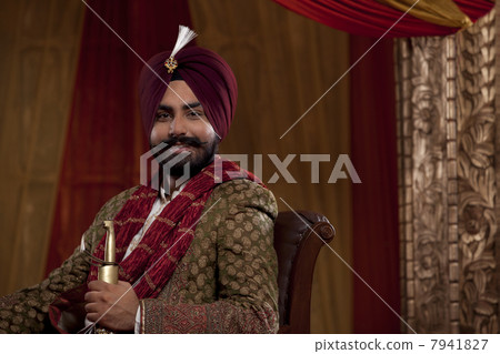 Portrait of Indian man holding sword 7941827