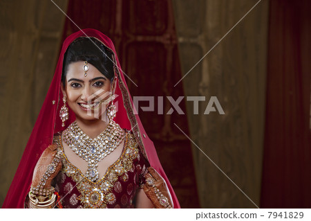 Portrait of an Indian bride in traditional clothing and jewelry Portrait of an Indian bride in traditional clothing and jewelry 7941829