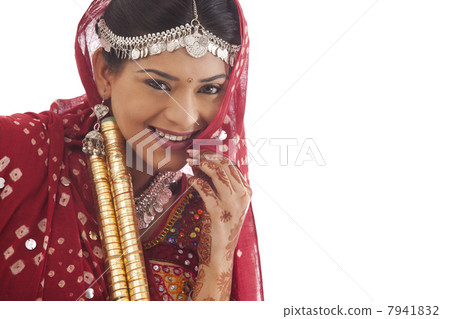 Portrait of a female dandiya dancer with sticks Portrait of a female dandiya dancer with sticks 7941832