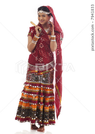 Portrait of a female dandiya dancer with sticks Portrait of a female dandiya dancer with sticks 7941833
