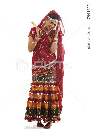 Portrait of a female dandiya dancer with sticks 7941835