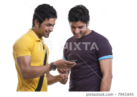 Friends reading text message on cell phone over white background 7941845