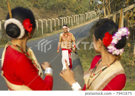 Bihu dancers look on as a Bihu man walks up to them Bihu dancers look on as a Bihu man walks up to them 7941875
