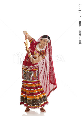 Female dandiya dancer dancing with sticks Female dandiya dancer dancing with sticks 7941887