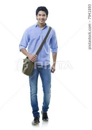 Smiling young man walking over white background 7941893