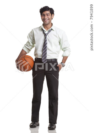 Businessman holding a basketball 7941899