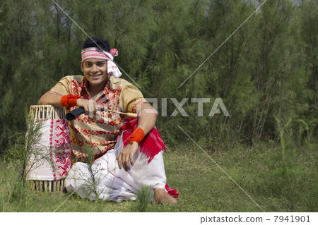 Portrait of a Bihu dancer sitting with a dhol 7941901