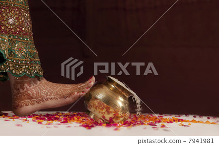 Brides foot kicking over a pot of rice Brides foot kicking over a pot of rice 7941981