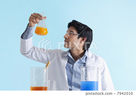 Scientist looking at solution 7942010