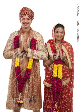 Portrait of a Gujarati bride and groom greeting 7942078