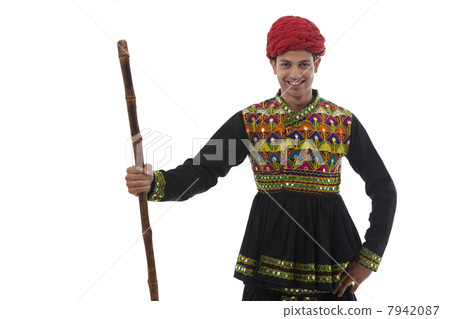 Portrait of a male dandiya dancer with a stick Portrait of a male dandiya dancer with a stick 7942087