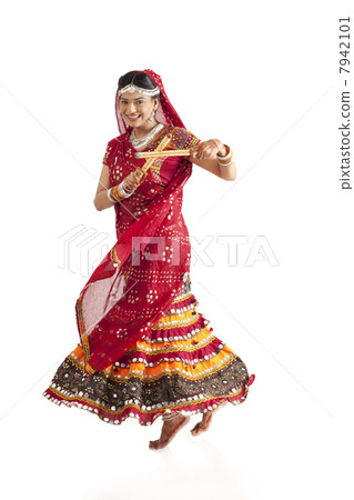 Female dandiya dancer dancing with sticks Female dandiya dancer dancing with sticks 7942101