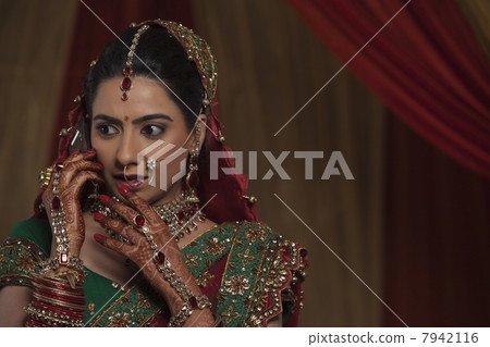 Close up of surprised young bride while talking on mobile phone 7942116