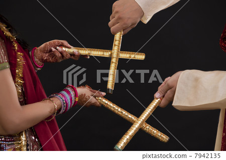 Couple with sticks dancing 7942135