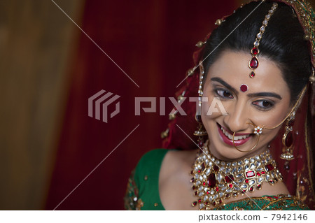 Close up of beautiful young woman smiling while looking away Close up of beautiful young woman smiling while looking away 7942146