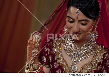 Shy woman in traditional dress smiling 7942203