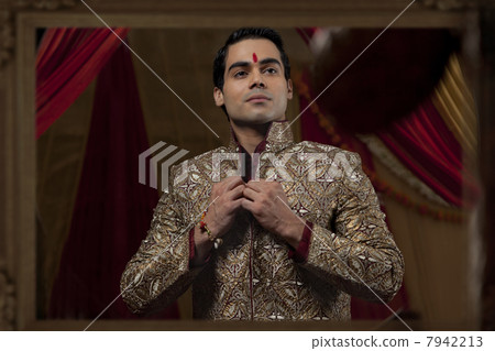 Mirror reflection young bridegroom getting dressedMirror reflection young bridegroom getting dressed 7942213