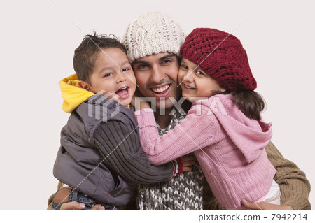 Son and daughter embracing father 7942214