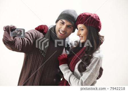 Young couple photographing themselves Young couple photographing themselves 7942218