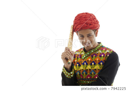 Portrait of a male dandiya dancer with sticks 7942225