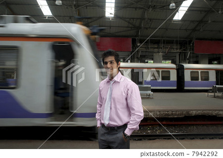 Businessman standing at a train station 7942292