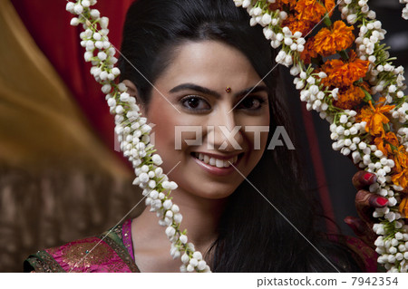 Portrait of smiling young woman with wreath 7942354