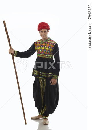 Portrait of a male dandiya dancer with a stick 7942421