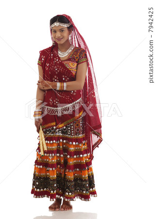 Portrait of a female dandiya dancer with sticks 7942425