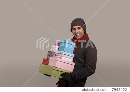 Portrait of young man carrying gift box 7942452