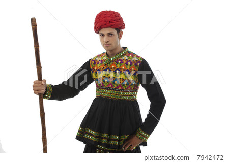 Portrait of a male dandiya dancer with a stick 7942472