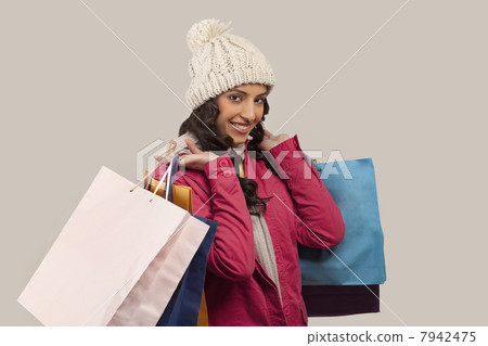Portrait of young woman with shopping bags 7942475