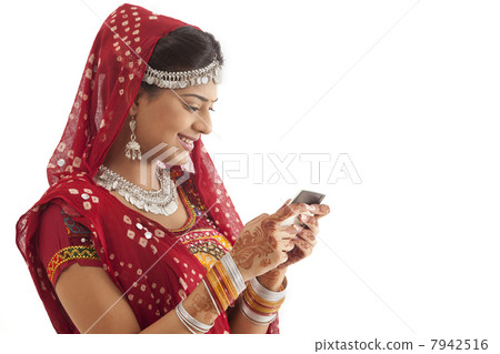 Female dandiya dancer reading an sms 7942516