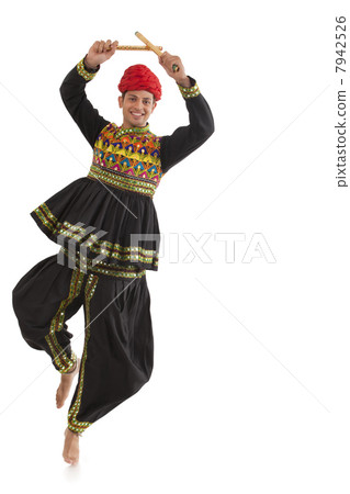 Male dandiya dancer dancing with sticks 7942526