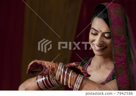 Indian bride admiring her bangles Indian bride admiring her bangles 7942586