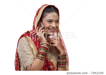 Gujarati bride talking on a mobile phone 7942594