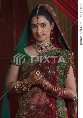 Portrait of beautiful young bride in traditional outfit 7942597