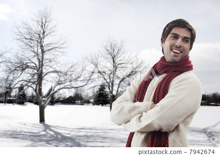 Young man with bare trees in the background 7942674
