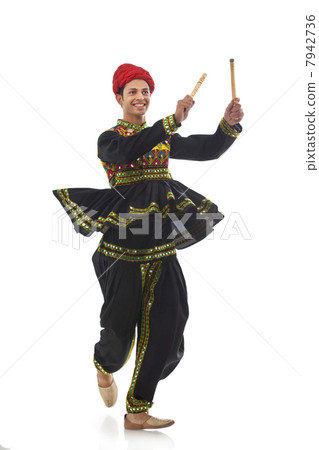 Male dandiya dancer dancing with sticks 7942736