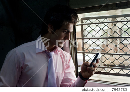 Businessman reading an sms in a train 7942783