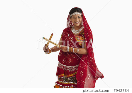 Portrait of a female dandiya dancer with sticks Portrait of a female dandiya dancer with sticks 7942784