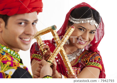 Portrait of couple with sticks dancing 7942793